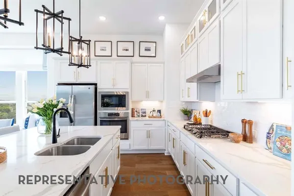 a kitchen with stainless steel appliances kitchen island granite countertop a sink and cabinets