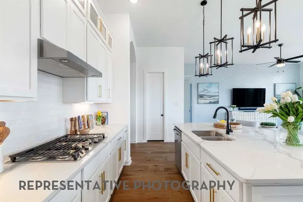 a kitchen with stainless steel appliances a sink stove and cabinets