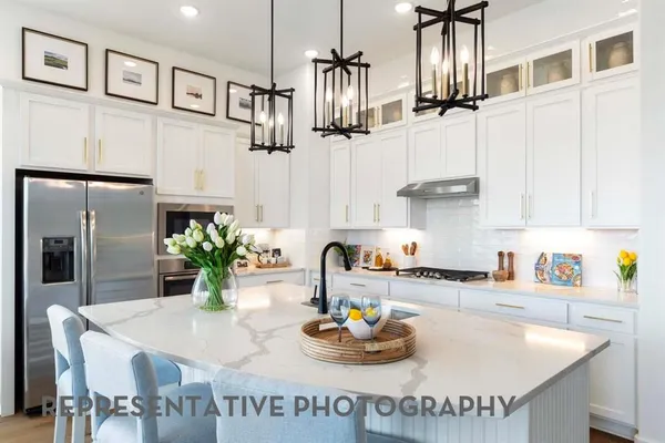 a kitchen with stainless steel appliances kitchen island granite countertop a sink and cabinets