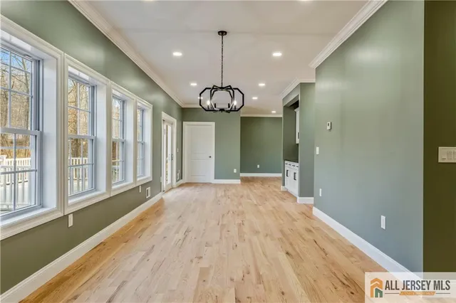 a view of a room with wooden floor and windows