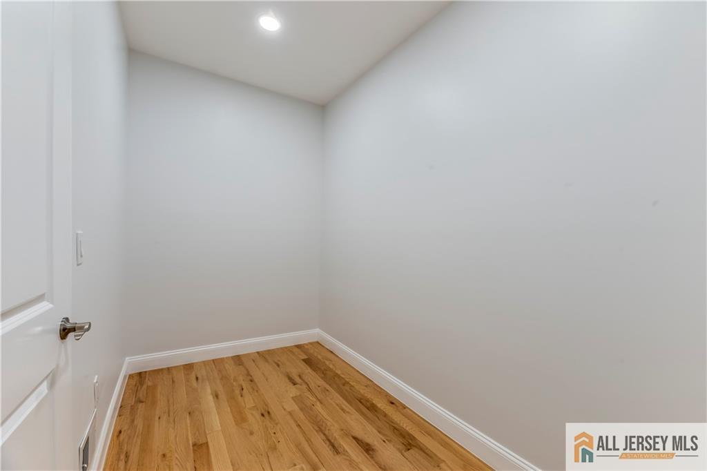 28 King George Road Warren, NJ 07059 - Photo 19 of 63 a view of a room with wooden floor and a bathroom