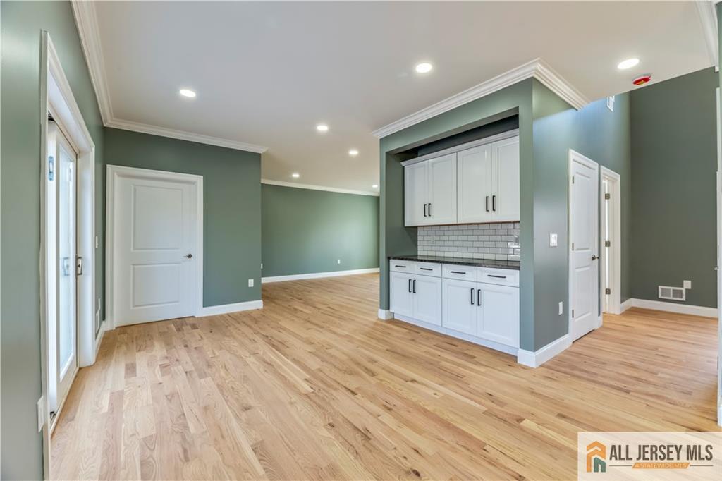28 King George Road Warren, NJ 07059 - Photo 20 of 63 a open kitchen with kitchen island white cabinets and stainless steel appliances