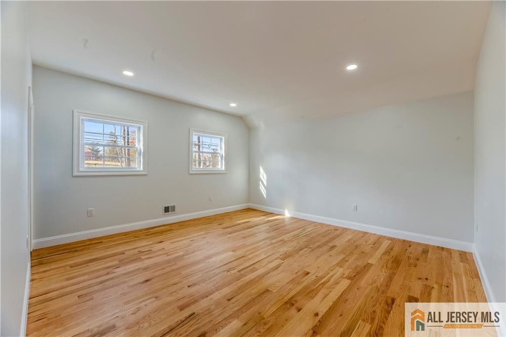 28 King George Road Warren, NJ 07059 - Photo 25 of 63 a view of empty room with wooden floor and fan