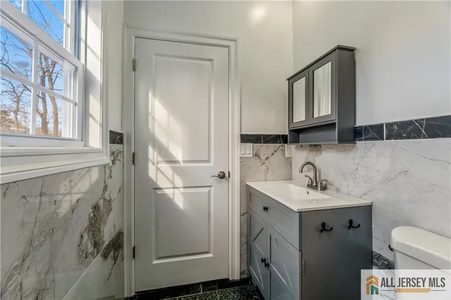 a bathroom with a sink toilet and mirror