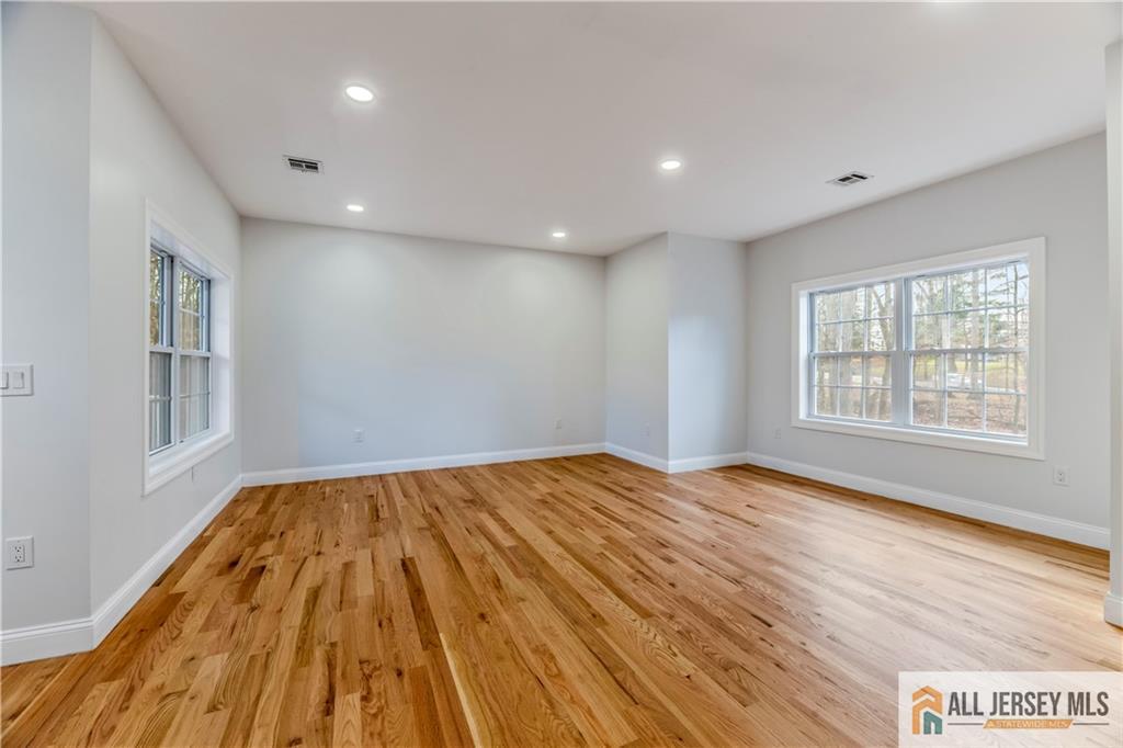 28 King George Road Warren, NJ 07059 - Photo 33 of 63 a view of an empty room with wooden floor and a window