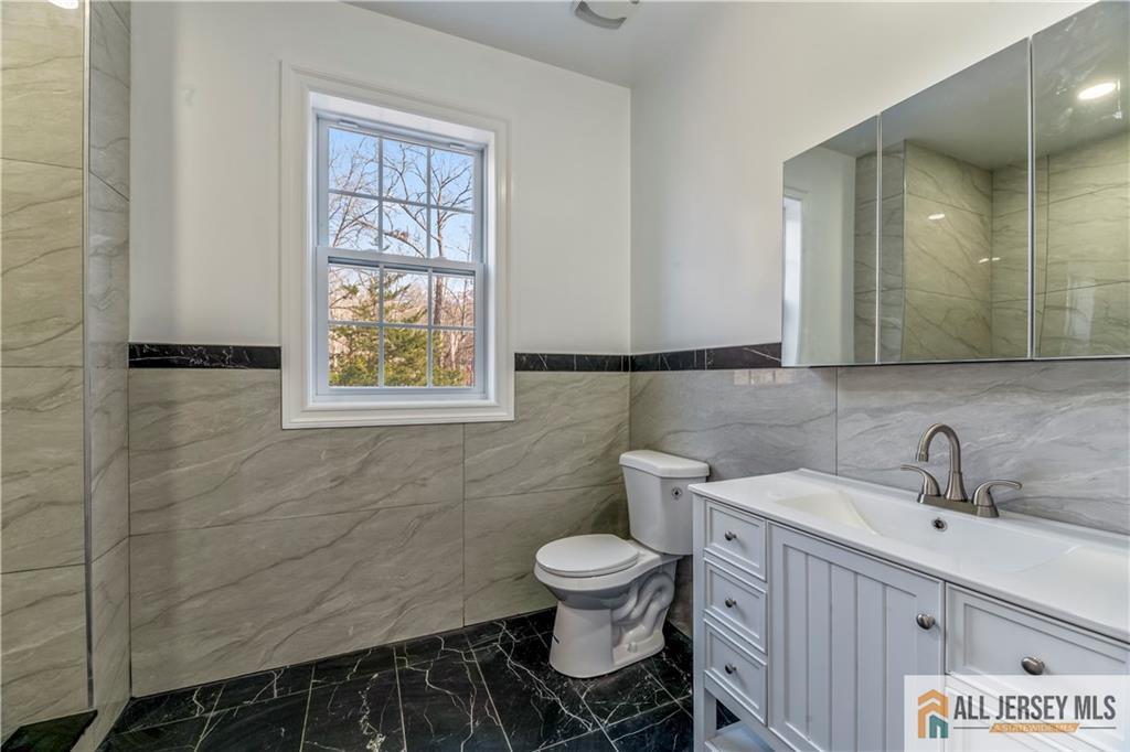 28 King George Road Warren, NJ 07059 - Photo 39 of 63 a bathroom with a toilet sink and mirror