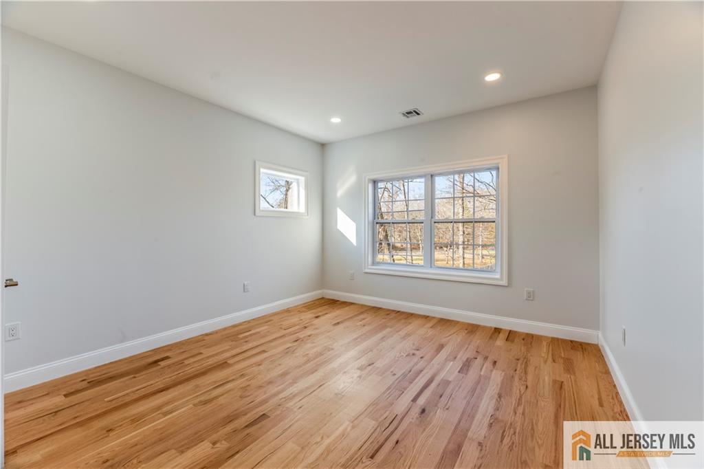 28 King George Road Warren, NJ 07059 - Photo 42 of 63 wooden floor in an empty room with a window