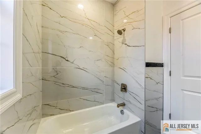 a backyard of a house with wooden deck and outdoor seating