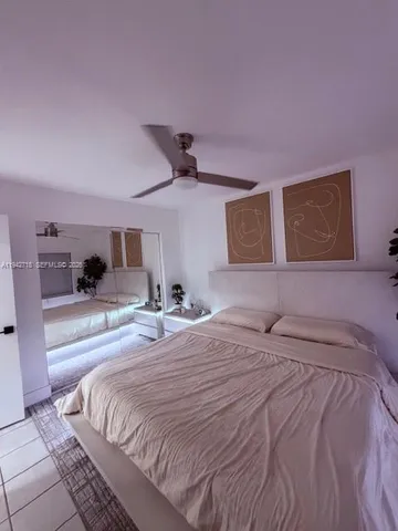 a bedroom with a large bed and a large window