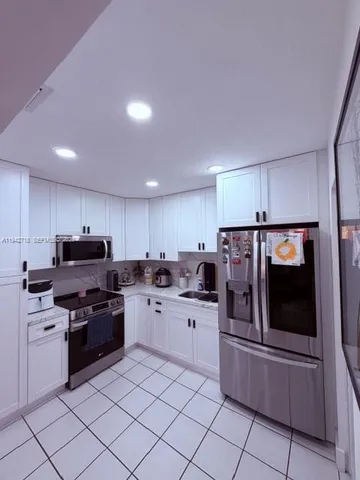 a kitchen with a sink and stainless steel appliances