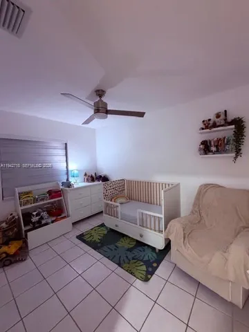 a living room with furniture and a book shelf