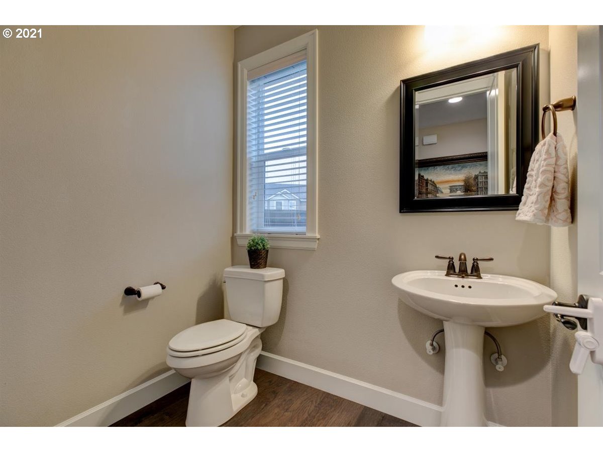 17468 Northwest Woodrush Way Portland, OR 97229 - Photo 12 of 32 a bathroom with a sink mirror and toilet