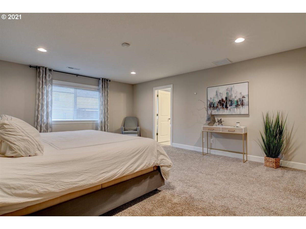 17468 Northwest Woodrush Way Portland, OR 97229 - Photo 14 of 32 a bedroom with a bed and a painting