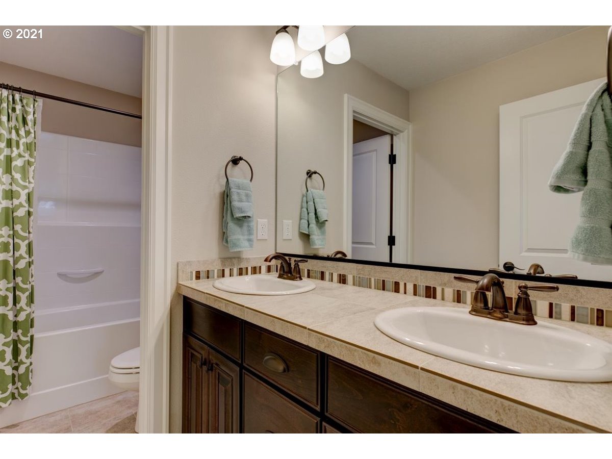 17468 Northwest Woodrush Way Portland, OR 97229 - Photo 19 of 32 a bathroom with a sink double vanity and a mirror