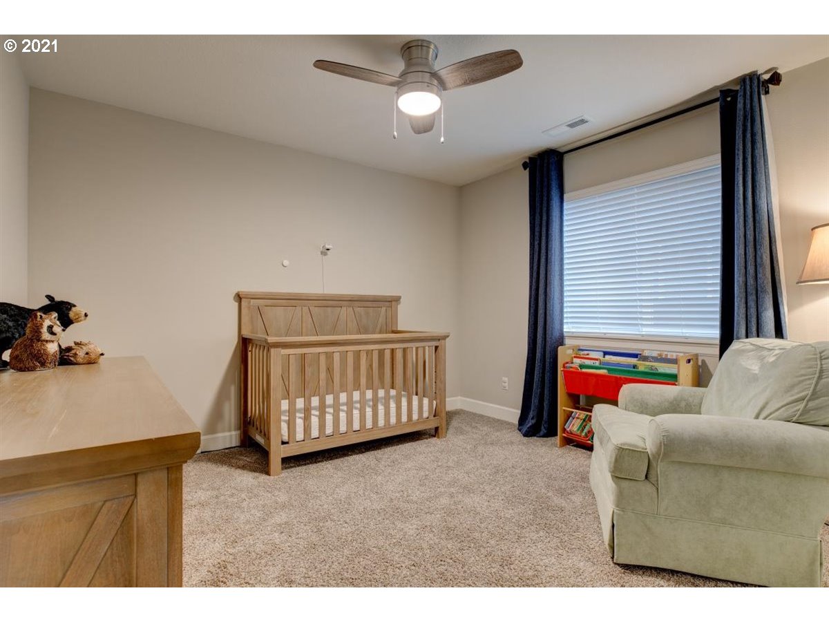 17468 Northwest Woodrush Way Portland, OR 97229 - Photo 20 of 32 a bedroom with furniture and a window