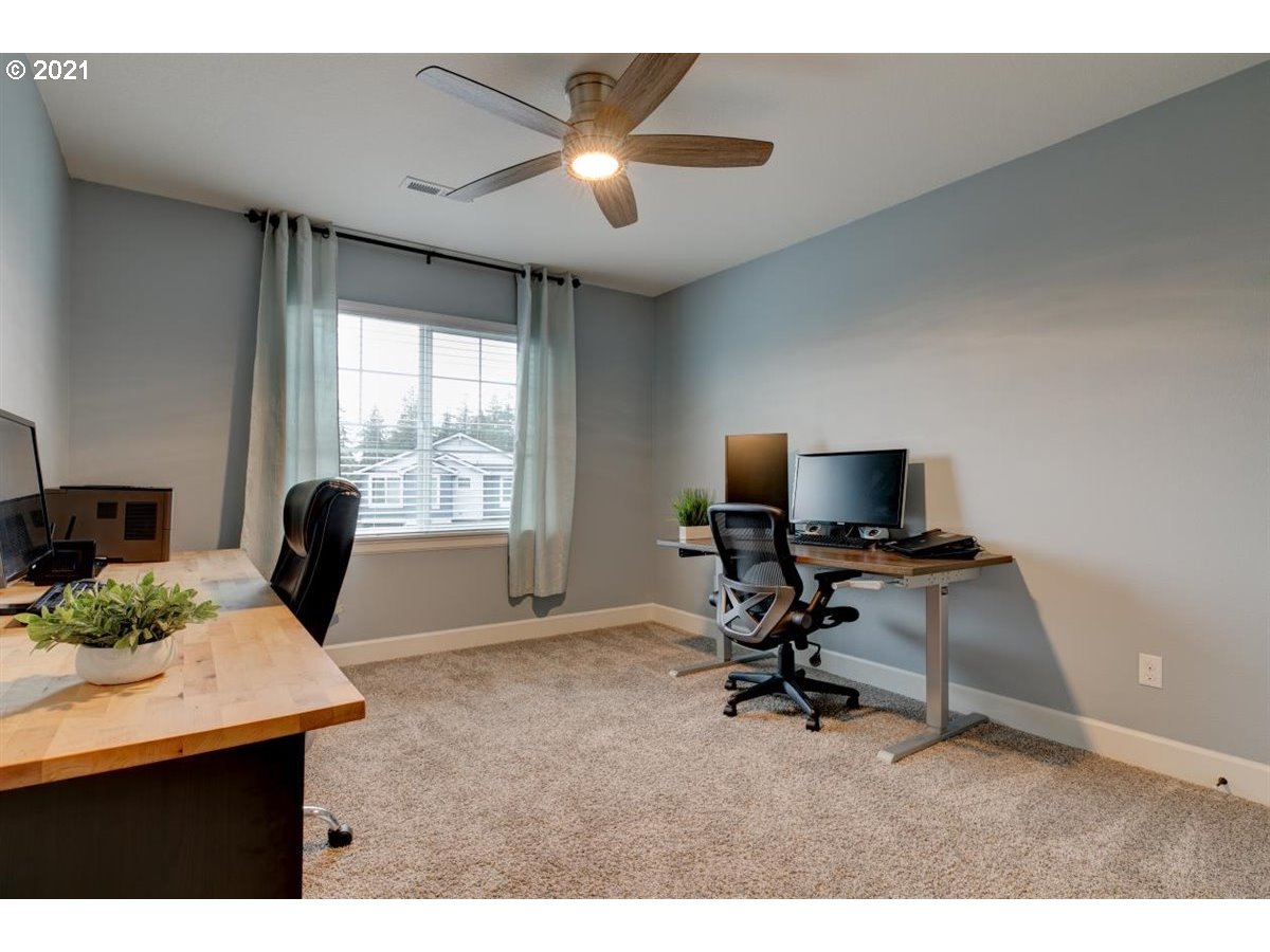 17468 Northwest Woodrush Way Portland, OR 97229 - Photo 22 of 32 a view of a workspace with furniture and a window