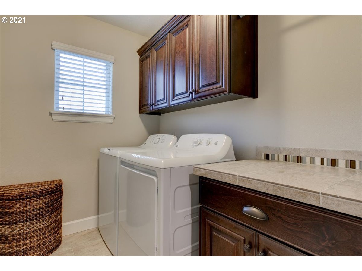17468 Northwest Woodrush Way Portland, OR 97229 - Photo 26 of 32 a bathroom with a sink and a mirror