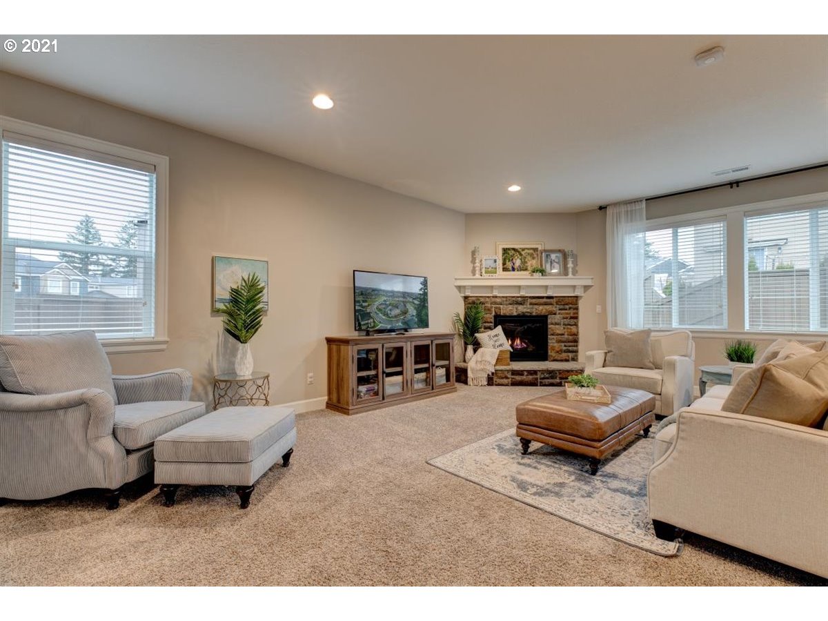 17468 Northwest Woodrush Way Portland, OR 97229 - Photo 4 of 32 a living room with furniture and a fireplace