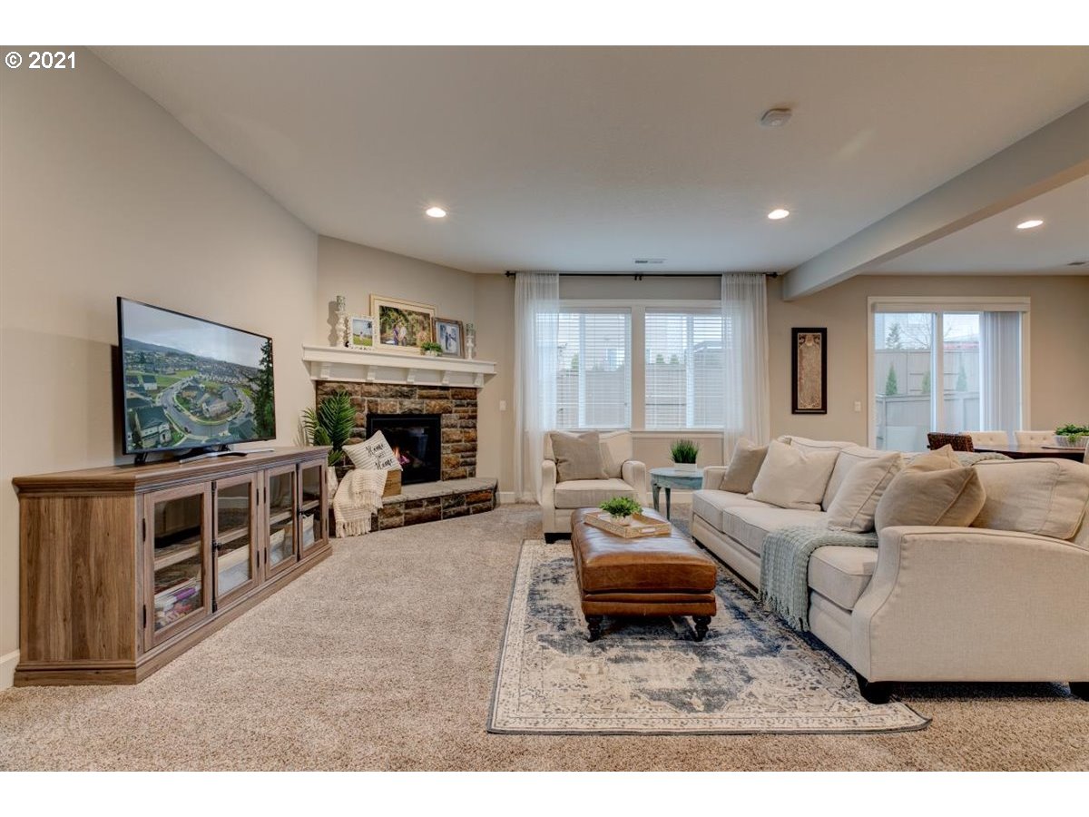 17468 Northwest Woodrush Way Portland, OR 97229 - Photo 5 of 32 a living room with furniture and a flat screen tv