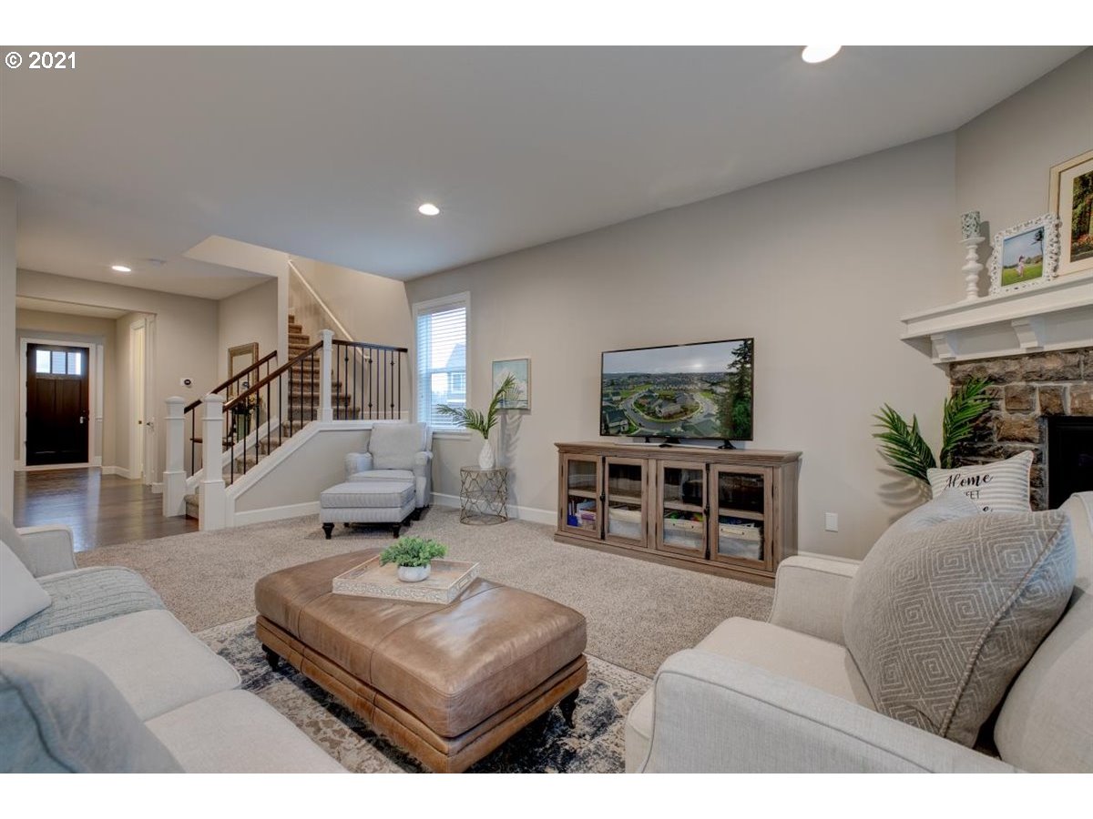 17468 Northwest Woodrush Way Portland, OR 97229 - Photo 6 of 32 a living room with furniture and a flat screen tv