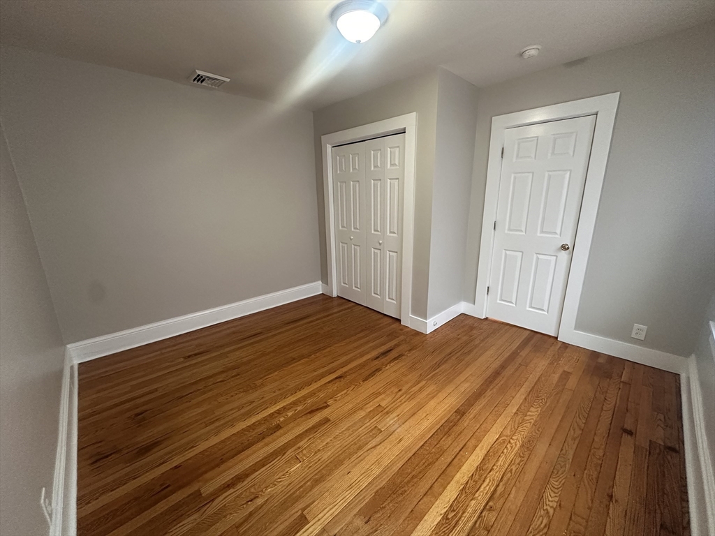 383 Newbury Street, Unit 2 Springfield, MA 01104 - Photo 7 of 11 a view of a room with wooden floor and windows
