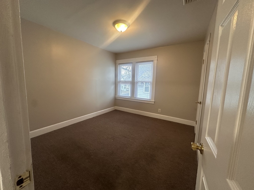 383 Newbury Street, Unit 2 Springfield, MA 01104 - Photo 9 of 11 an empty room with windows and closet