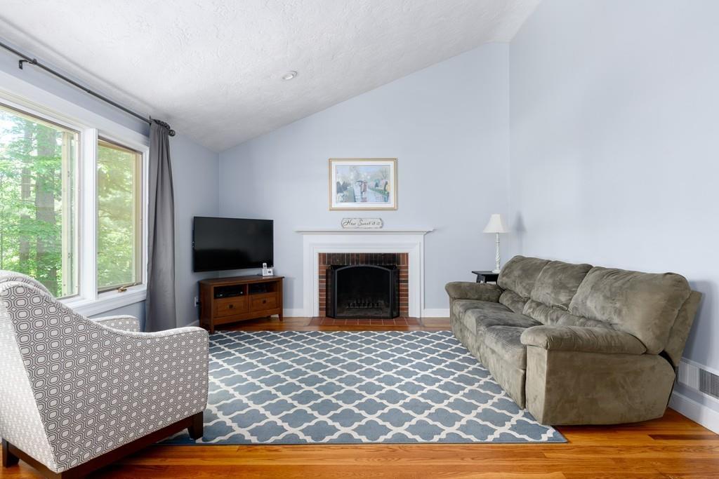 9 Highgate Road Wayland, MA 01778 - Photo 7 of 21 a living room with furniture a flat screen tv and a fireplace