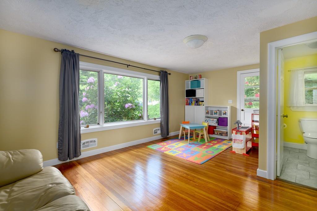 9 Highgate Road Wayland, MA 01778 - Photo 10 of 21 a living room with furniture and a large window
