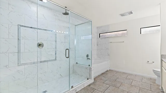 a bathroom with a shower and a sink
