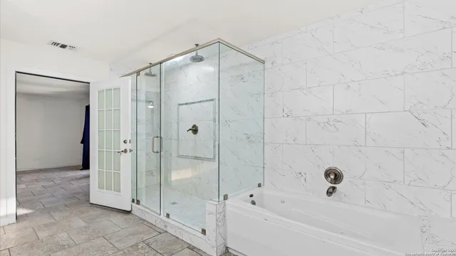 a bathroom with a bathtub and a shower