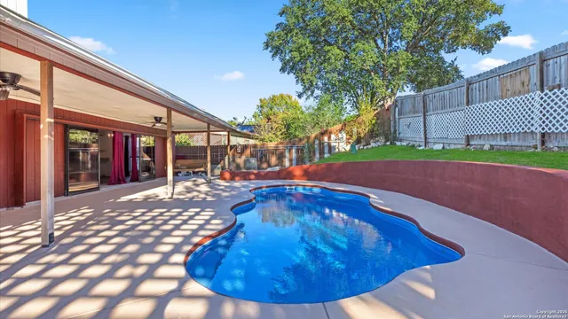 a view of a backyard with a swimming pool