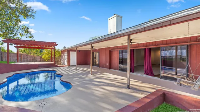 a view of a house with backyard and sitting area