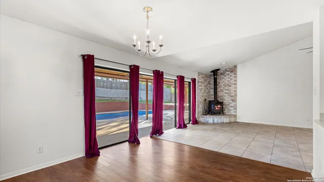 a view of a room with wooden floor and windows