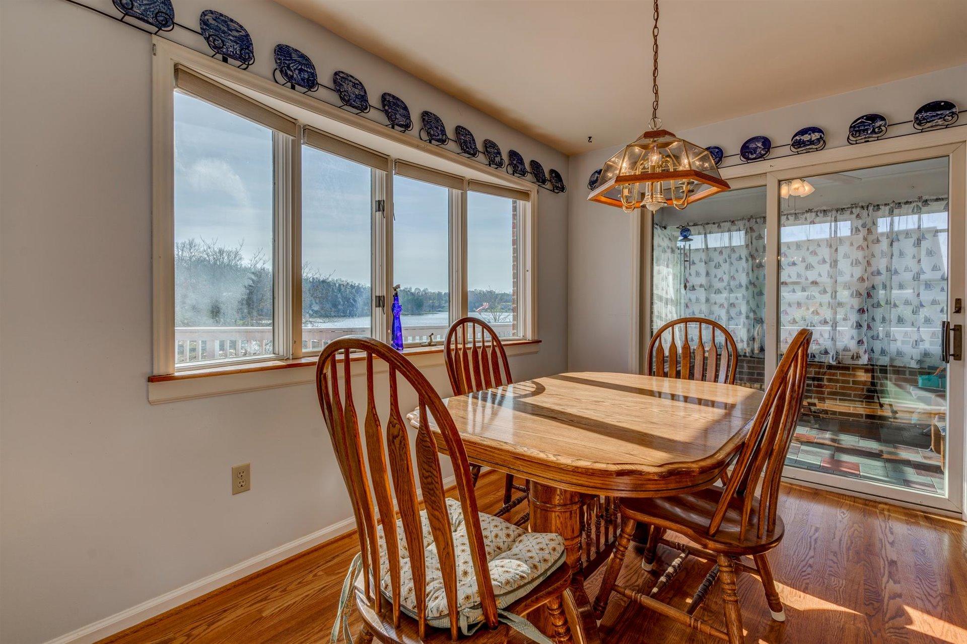 171 Sandy Point Court Union Hall, VA 24176 - Photo 13 of 65 a dining room with furniture a chandelier and wooden floor