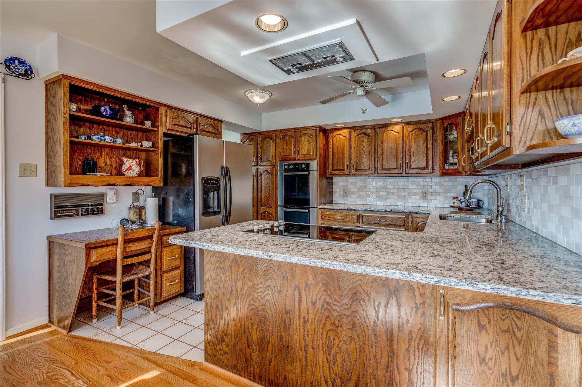 171 Sandy Point Court Union Hall, VA 24176 - Photo 14 of 65 a kitchen with stainless steel appliances granite countertop a sink and a refrigerator