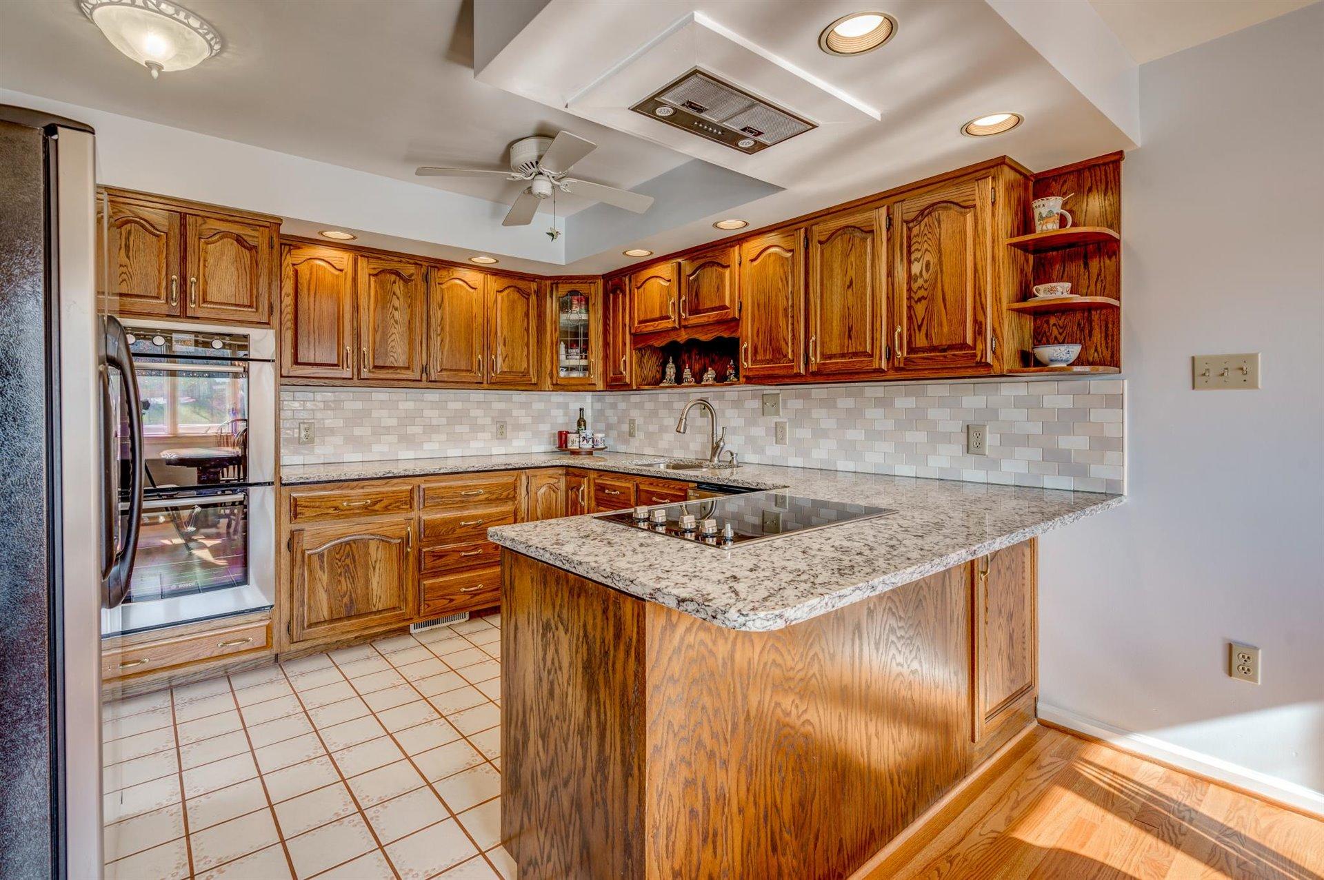 171 Sandy Point Court Union Hall, VA 24176 - Photo 15 of 65 a kitchen with stainless steel appliances granite countertop a sink stove and cabinets