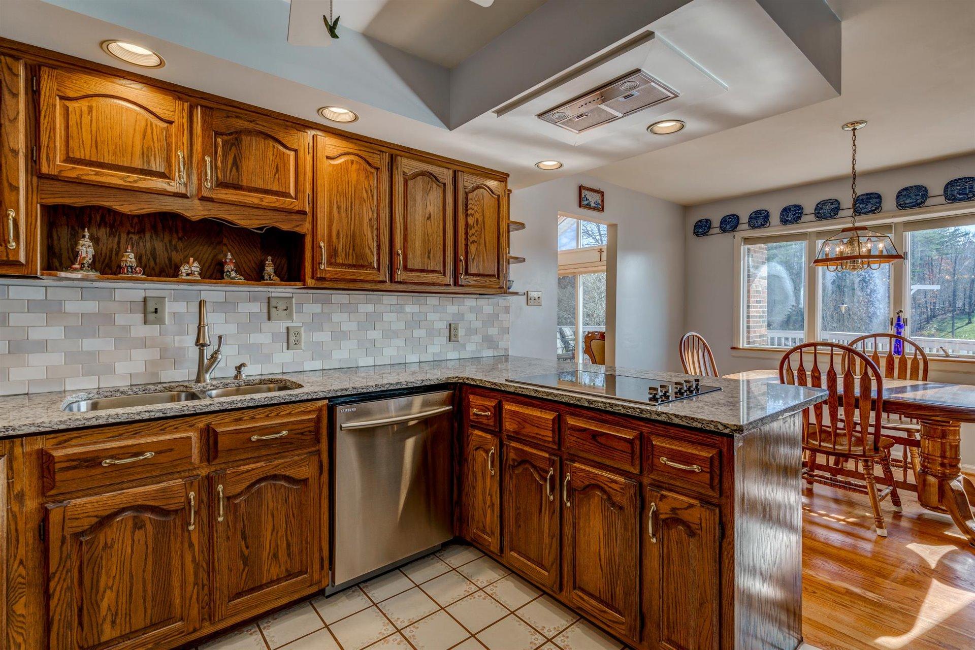 171 Sandy Point Court Union Hall, VA 24176 - Photo 16 of 65 a kitchen with stainless steel appliances granite countertop a sink and cabinets