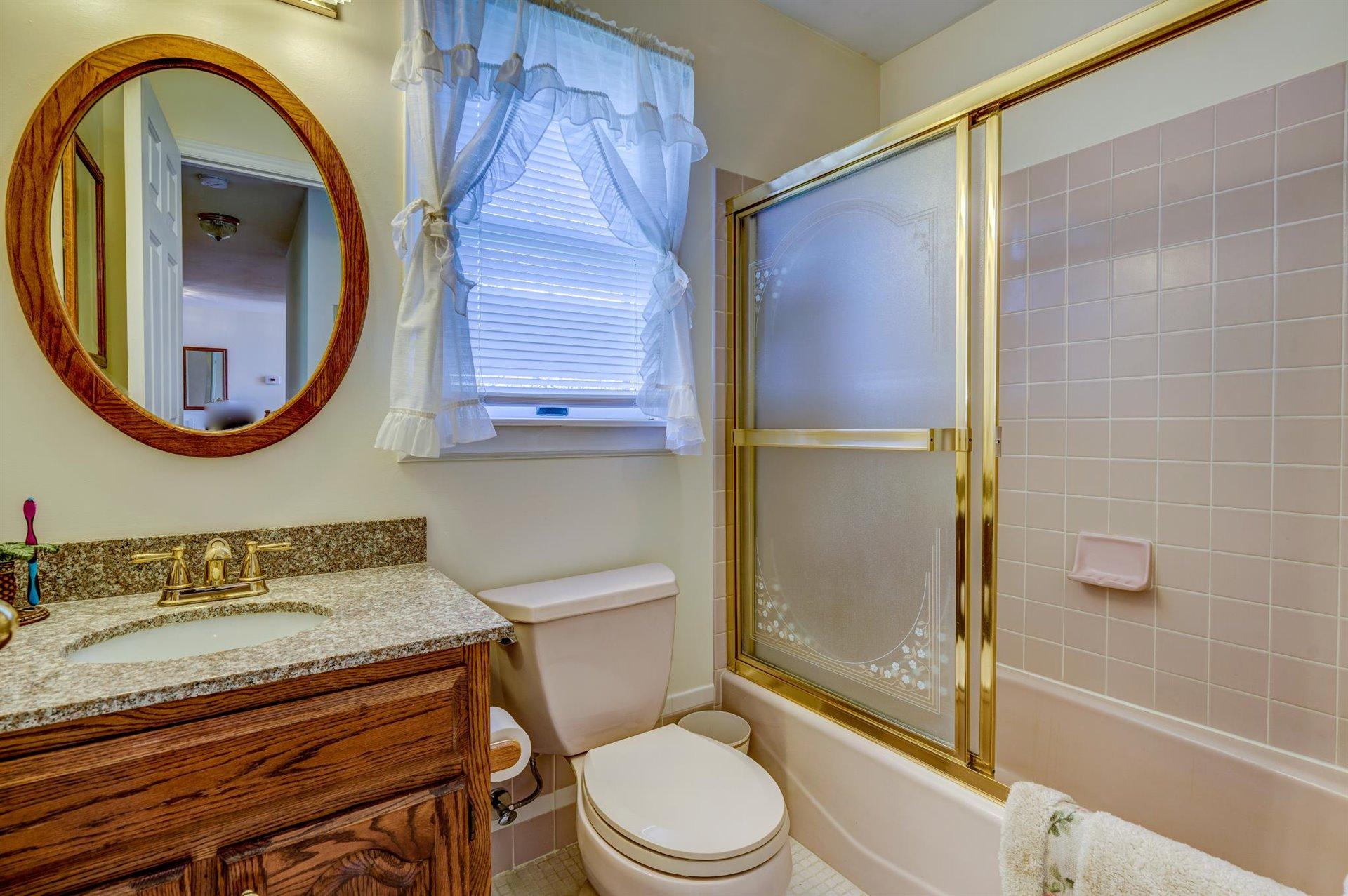 171 Sandy Point Court Union Hall, VA 24176 - Photo 29 of 65 a bathroom with a granite countertop toilet sink and mirror