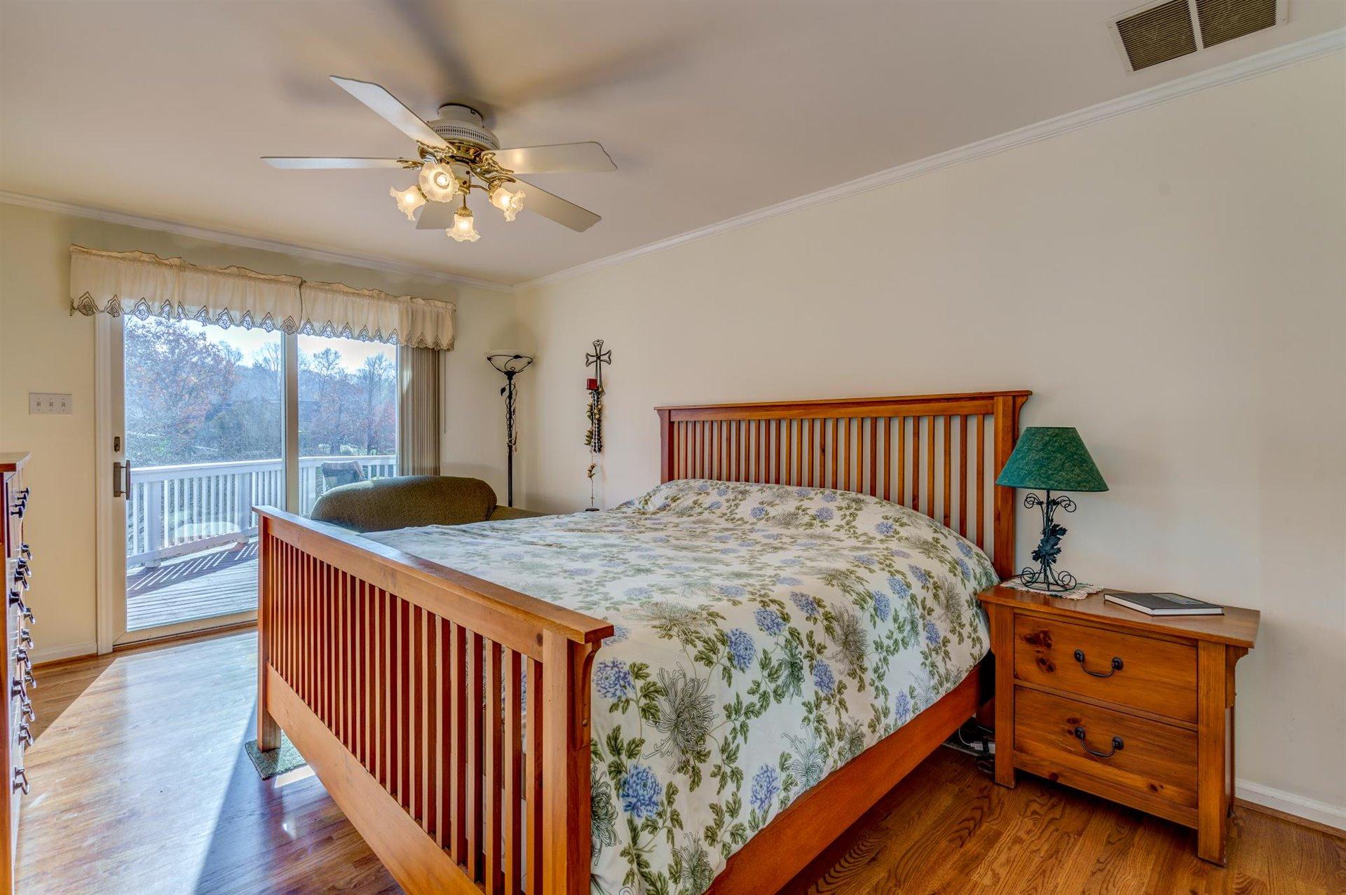 171 Sandy Point Court Union Hall, VA 24176 - Photo 30 of 65 a bedroom with a bed and wooden floor