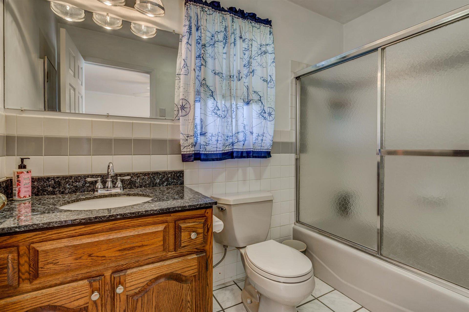 171 Sandy Point Court Union Hall, VA 24176 - Photo 32 of 65 a bathroom with a granite countertop toilet sink and shower