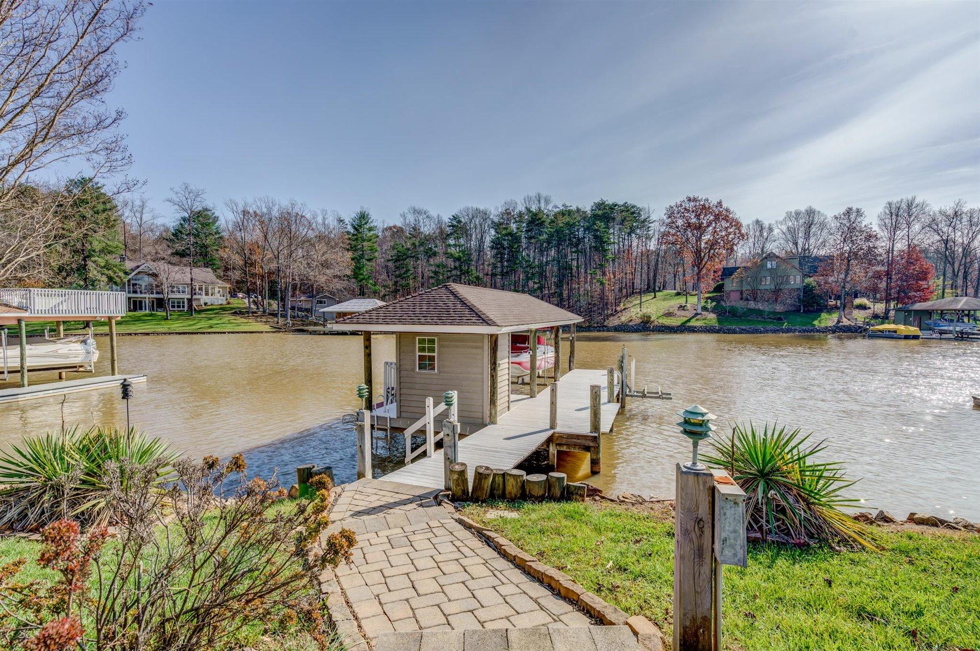 171 Sandy Point Court Union Hall, VA 24176 - Photo 51 of 65 a view of a lake with a table and chairs