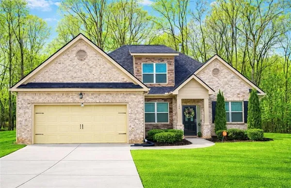a front view of a house with a yard and garage