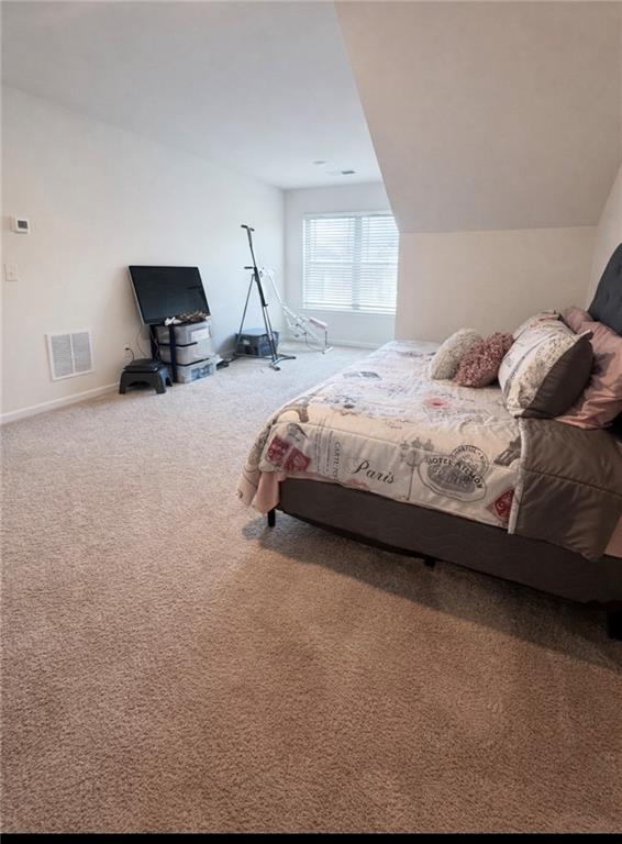 208 Sebastian Cove Hampton, GA 30228 - Photo 13 of 15 a spacious bedroom with a bed a couch and large window