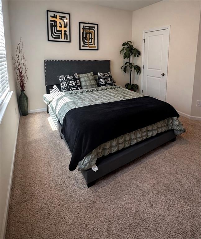 208 Sebastian Cove Hampton, GA 30228 - Photo 15 of 15 a bedroom with a bed and ceiling fan