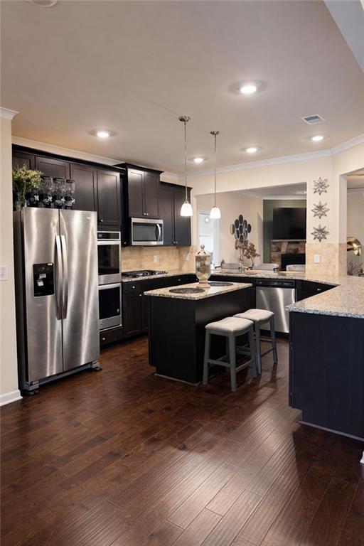 208 Sebastian Cove Hampton, GA 30228 - Photo 5 of 15 a kitchen with stainless steel appliances a refrigerator and a stove top oven