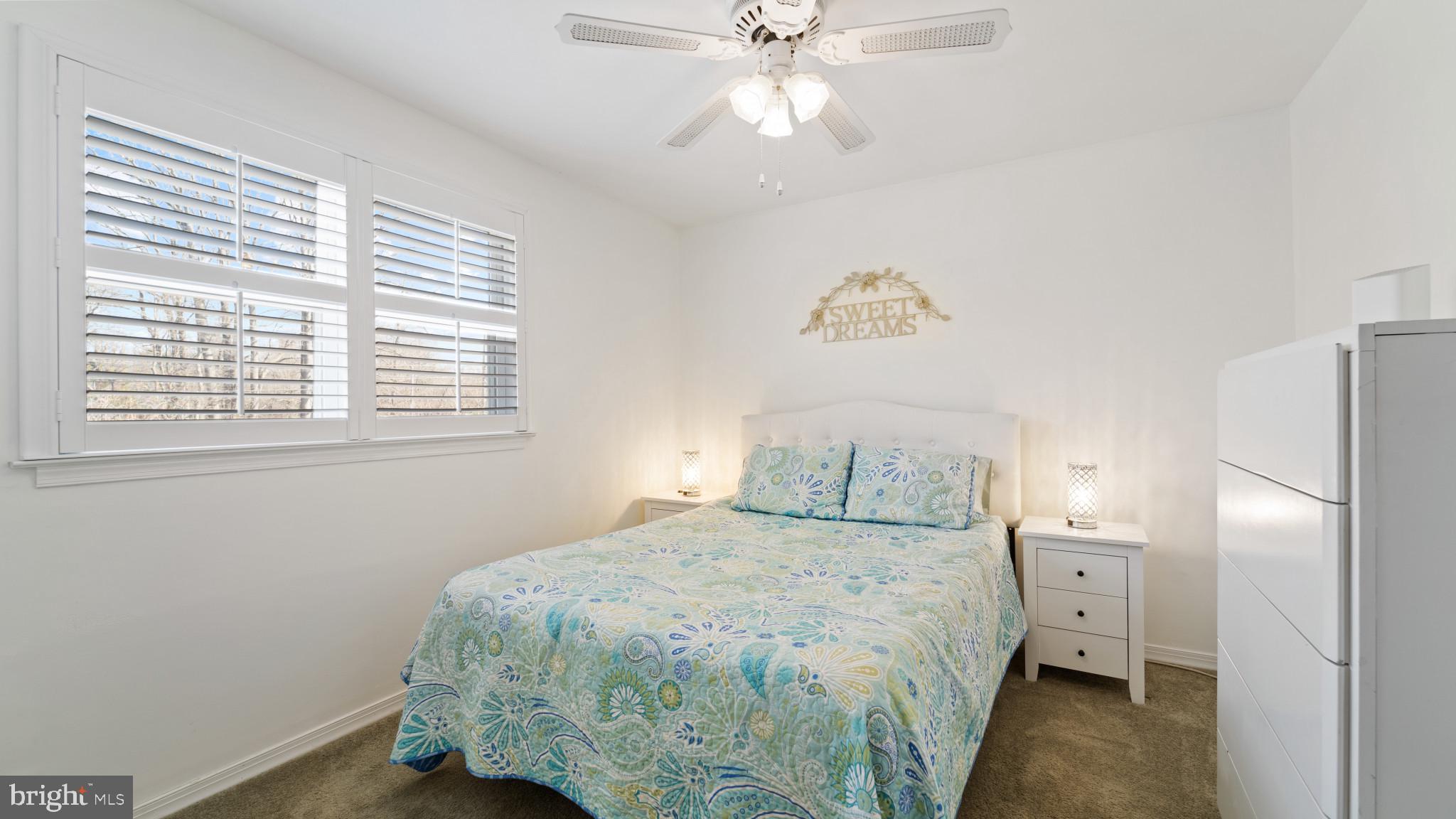 93 Harmony Road Mickleton, NJ 08056 - Photo 15 of 34 a bedroom with a large bed and a chandelier