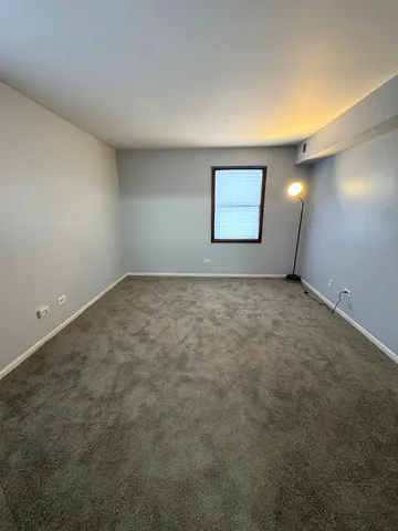 an empty room with mirror and entrance