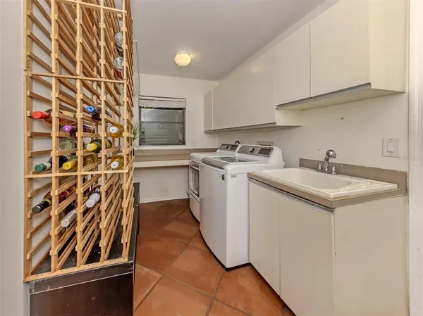 a utility room with sink dryer and washer