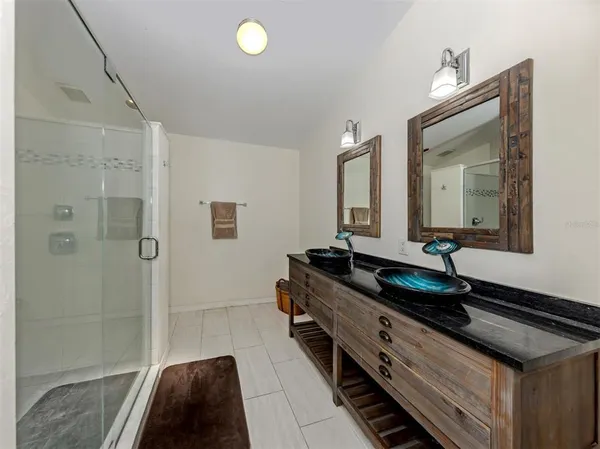 a bathroom with a double vanity sink and mirror