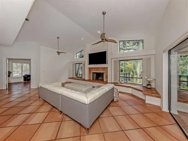 a living room with a large window and a fireplace